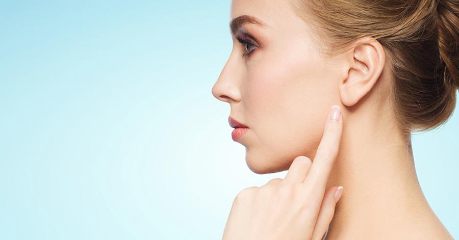 woman pointing towards her ear