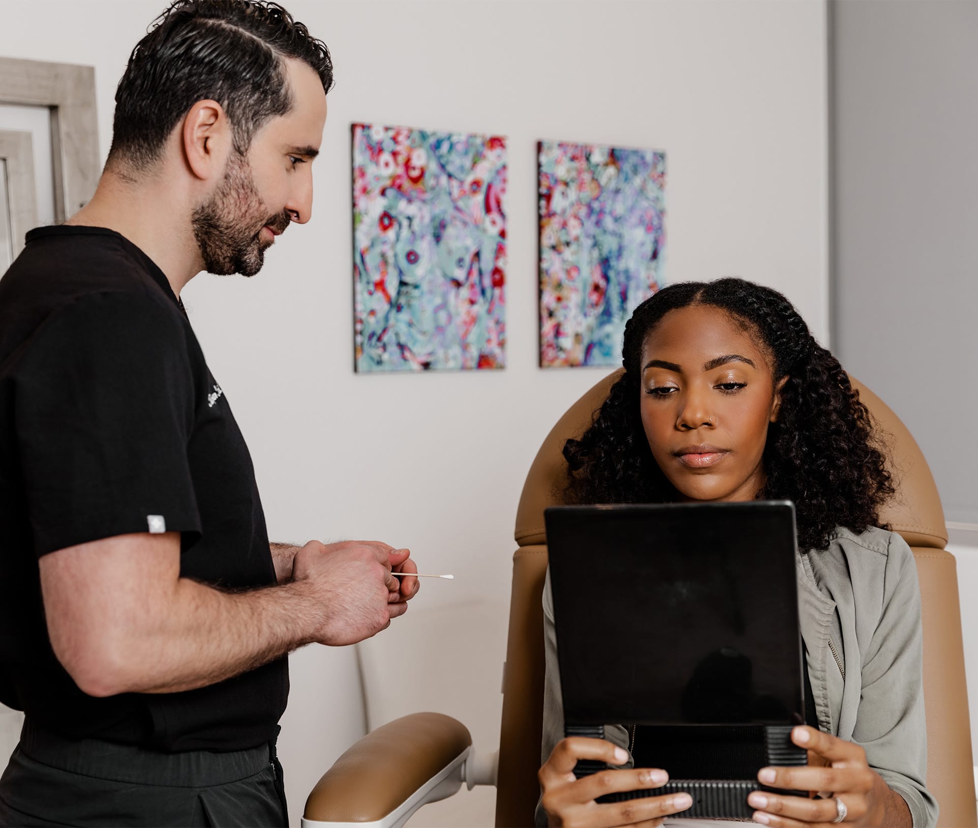 woman looking at herself in a mirror with doctor