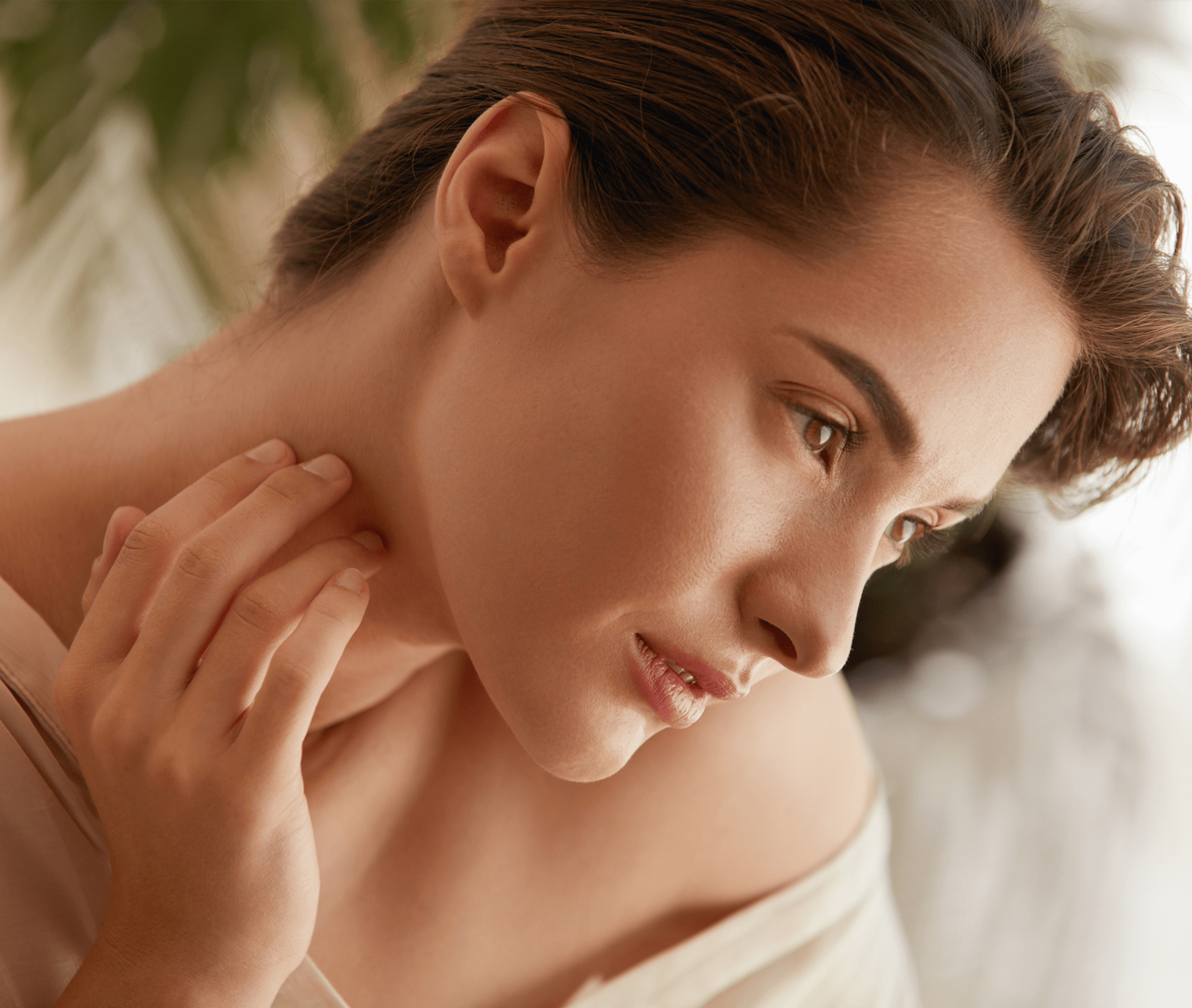 woman touching her neck