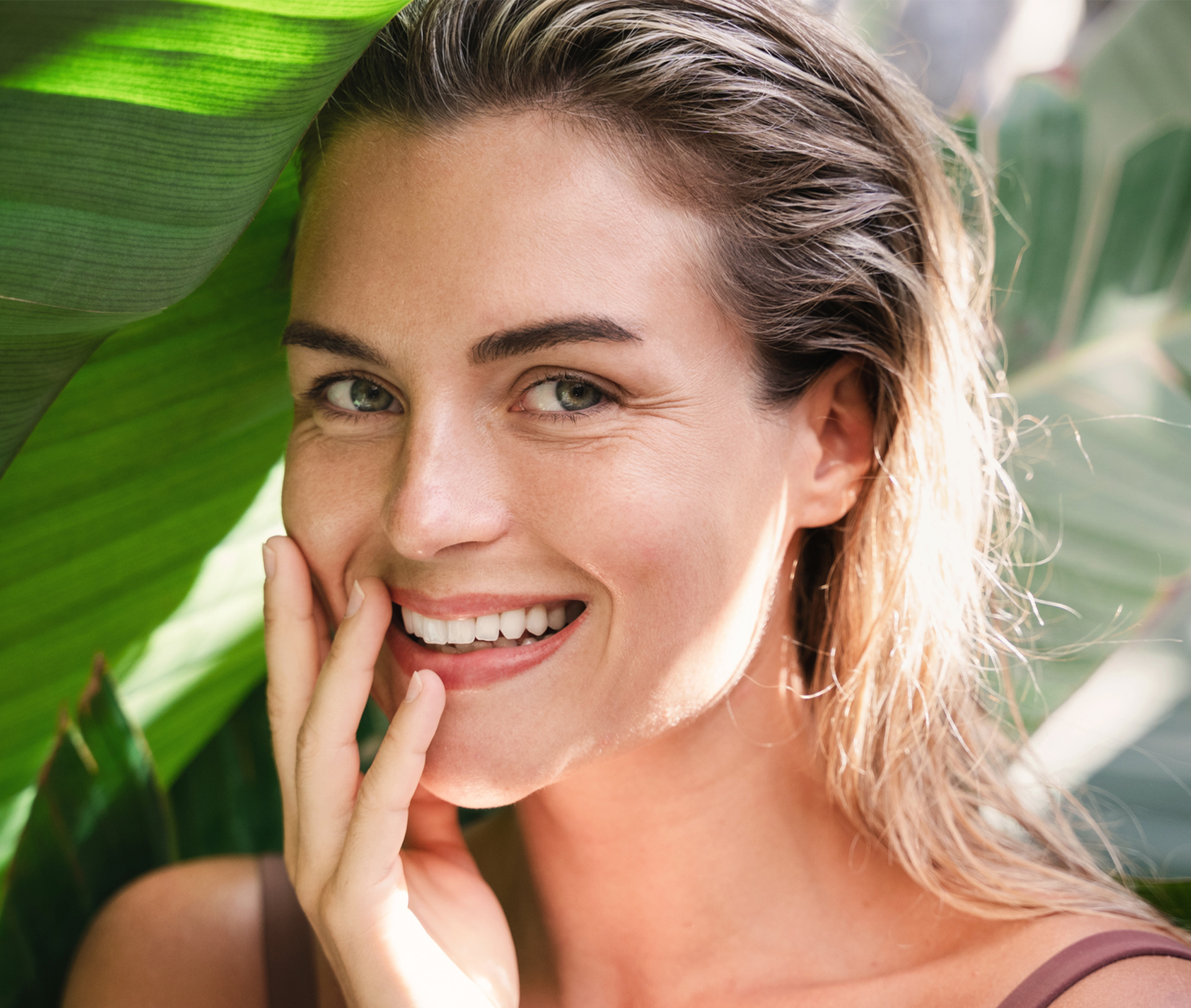 smiling woman touching her face