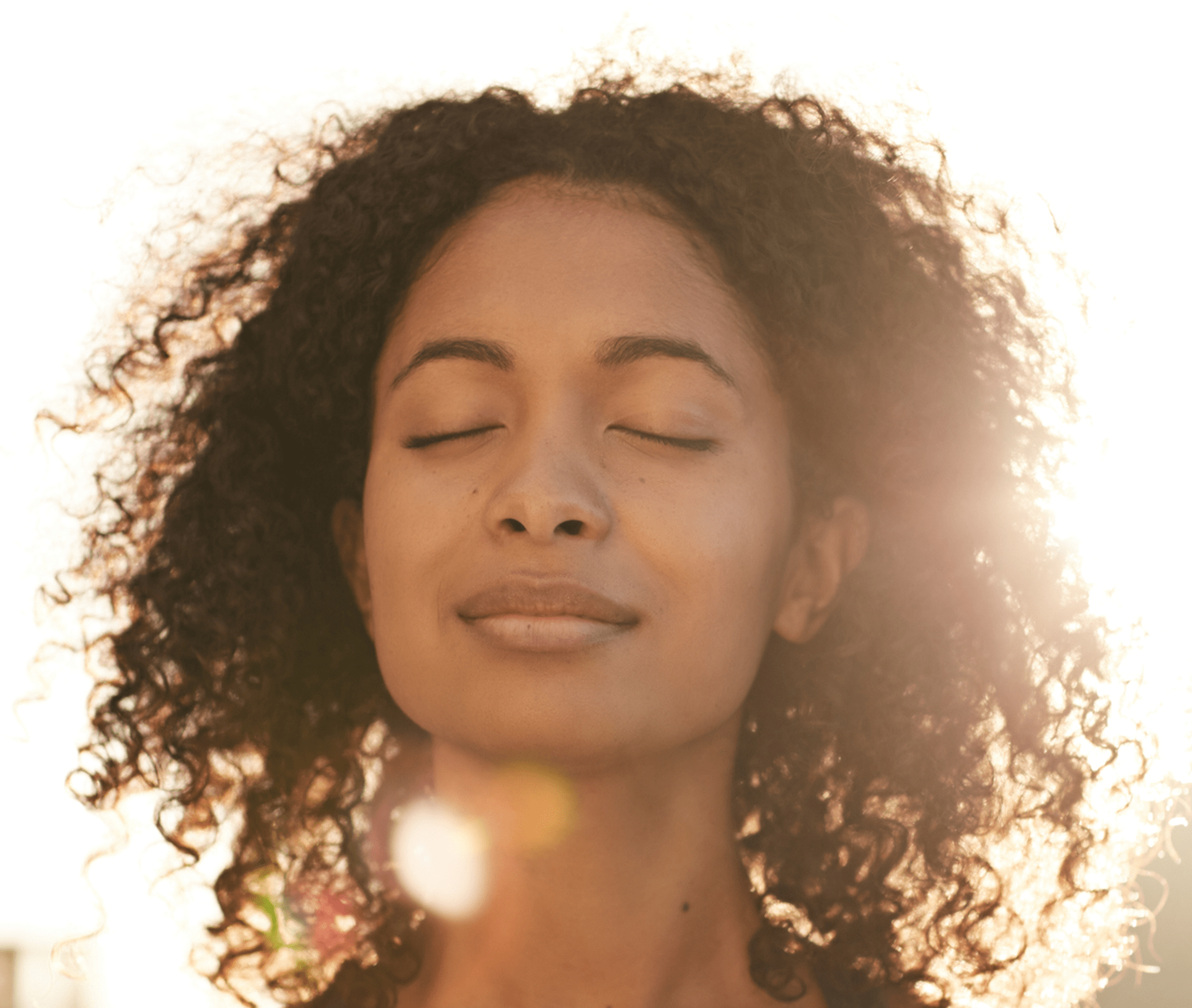 woman smiling with her eyes closed