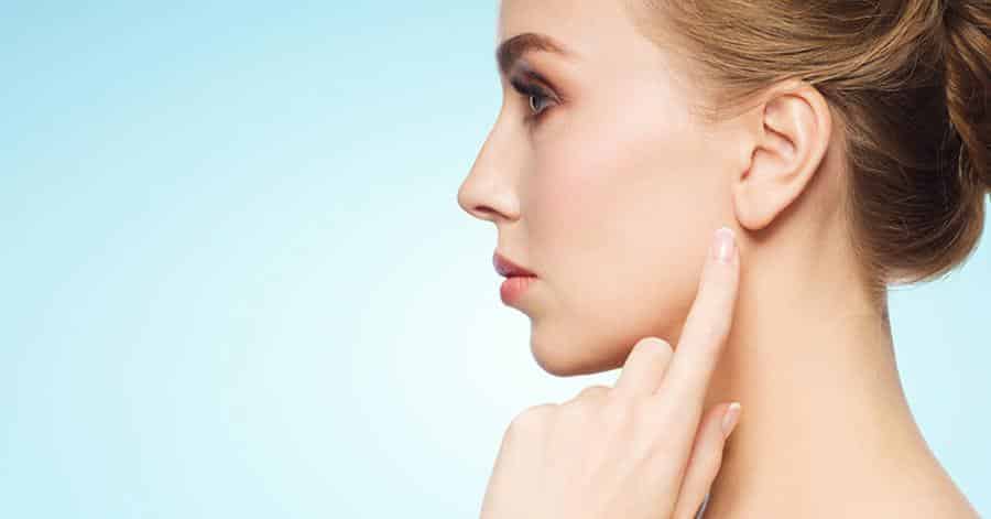 woman pointing towards her ear