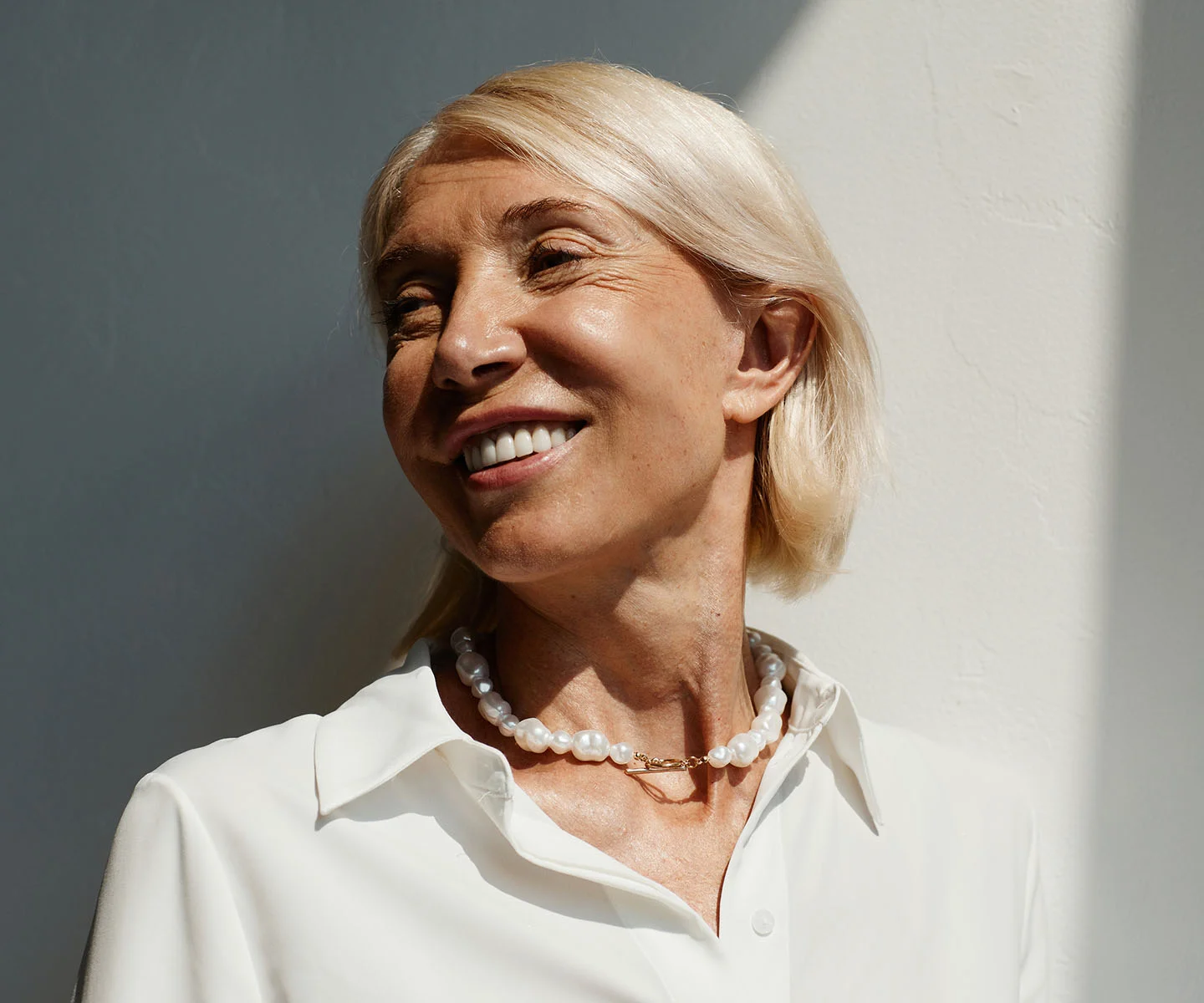 A focused beauty shot of a woman’s eyes and forehead area. Her eyebrows are well-defined and positioned symmetrically, and her gaze is clear and alert. The lighting is bright and even, highlighting the brightness of her eyes and the refreshed appearance of the upper face against a soft, out-of-focus background. - Eyebrow ptsosis in Arizona